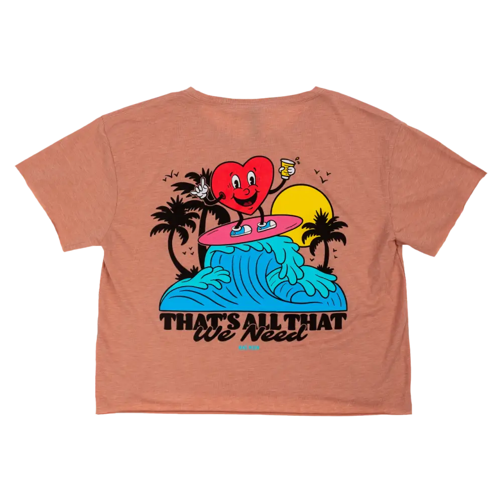 Peach-colored crop top t-shirt with a colorful cartoon heart surfing design on the back.