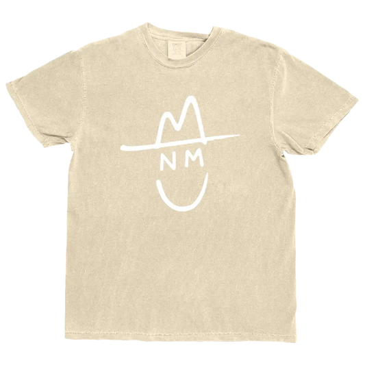 Beige cotton t-shirt featuring a white graphic of a stylized hat with ’nm’ initials and a smiley face underneath.