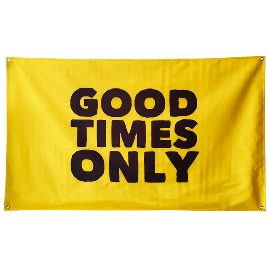 Yellow flag with black text reading ’GOOD TIMES ONLY’.