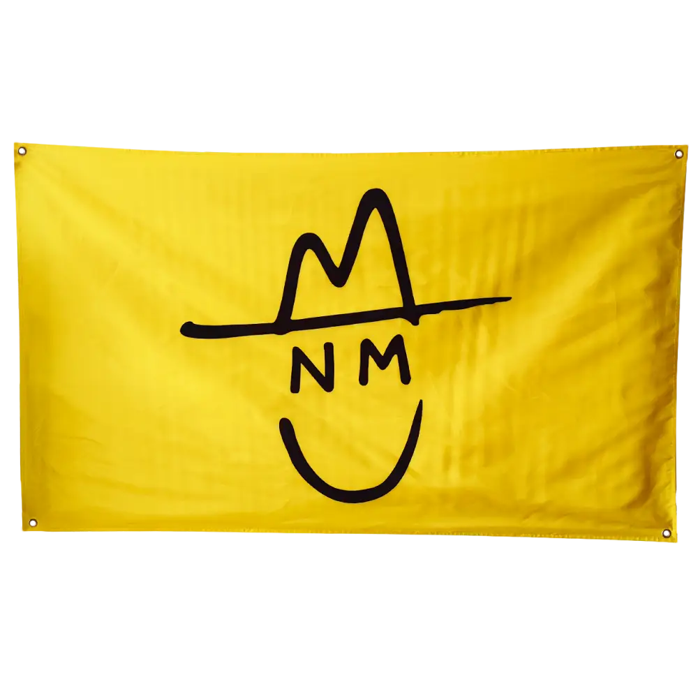 Yellow flag with a black stylized cowboy hat and smiley face logo containing the letters ’NM’.