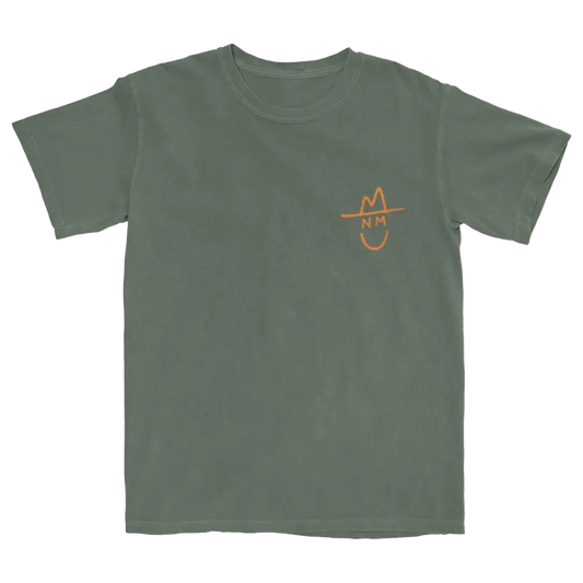 Green t-shirt with a small orange smiley face design on the chest.