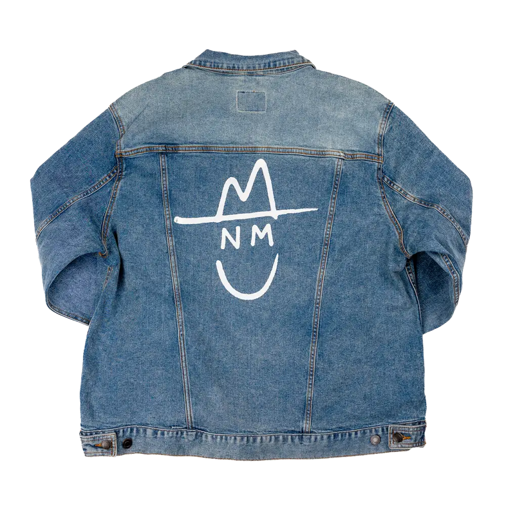 Denim jacket with a white ’NM’ logo and smiley face design on the back.
