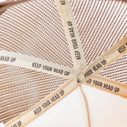 Interior of a brown mesh cap with supportive bands.