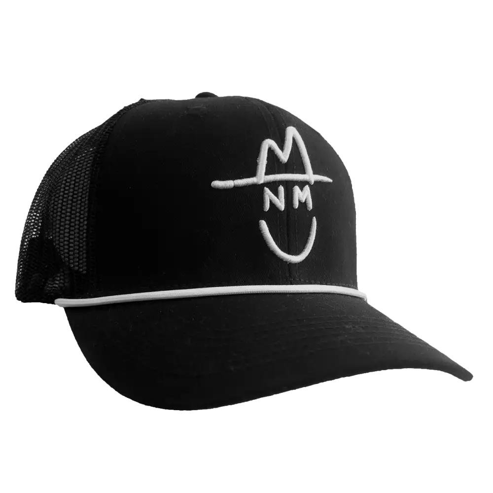Black trucker-style baseball cap with white ’NM’ logo embroidery.