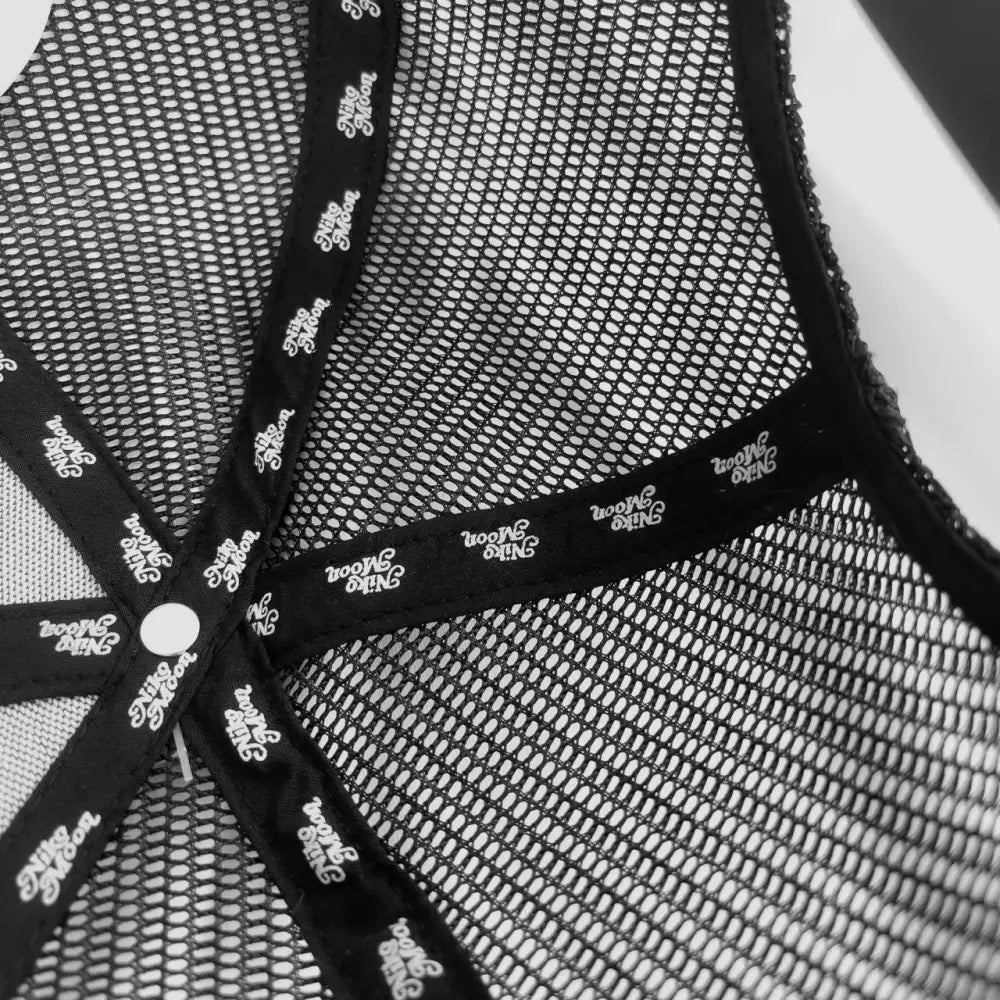 Mesh fabric with decorative floral trim forming a star-like pattern.