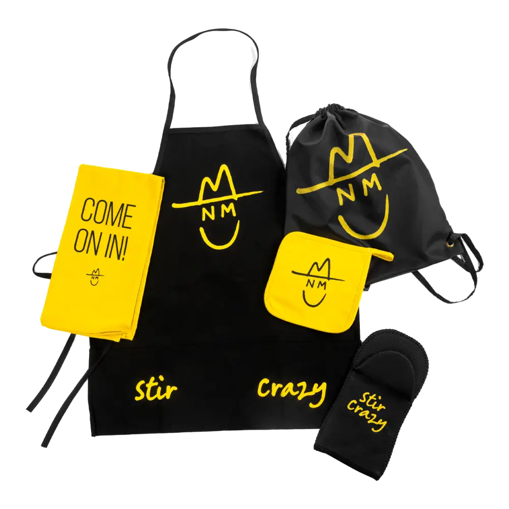 Collection of branded kitchen accessories including an apron, oven mitt, drawstring bag, and notebook featuring a yellow and black color scheme with a smiley face logo.