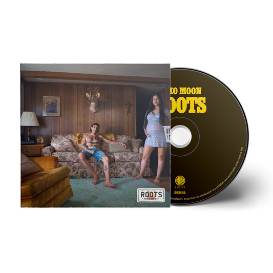 CD cover with a couple in a living room and 'Mo' Moon Roots' text.