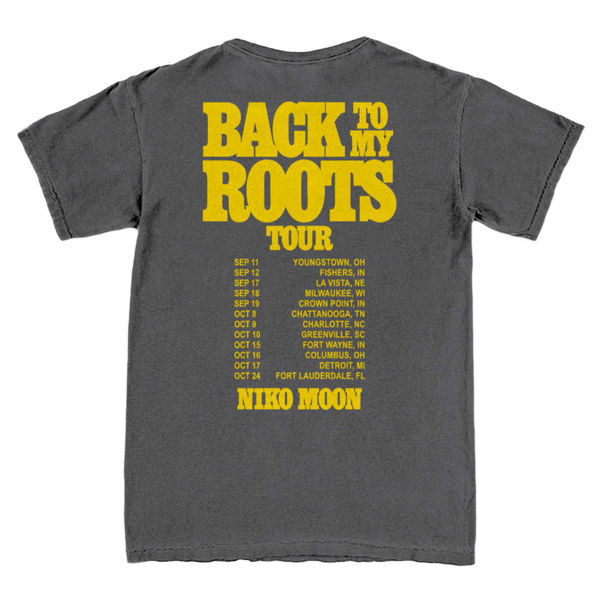 A dark gray t-shirt showing the back side with a large yellow graphic print that reads 'BACK TO MY ROOTS TOUR' and lists tour dates with 'NICO MOON'.