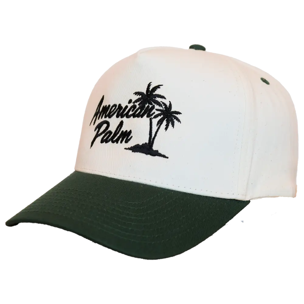 White and dark green two-tone baseball cap featuring black embroidered ’american palm’ text with a palm tree design.