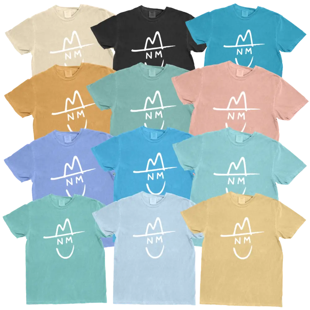 A collection of soft, pastel-colored cotton t-shirts featuring a white minimalist logo with an ’nm’ monogram and hat design.