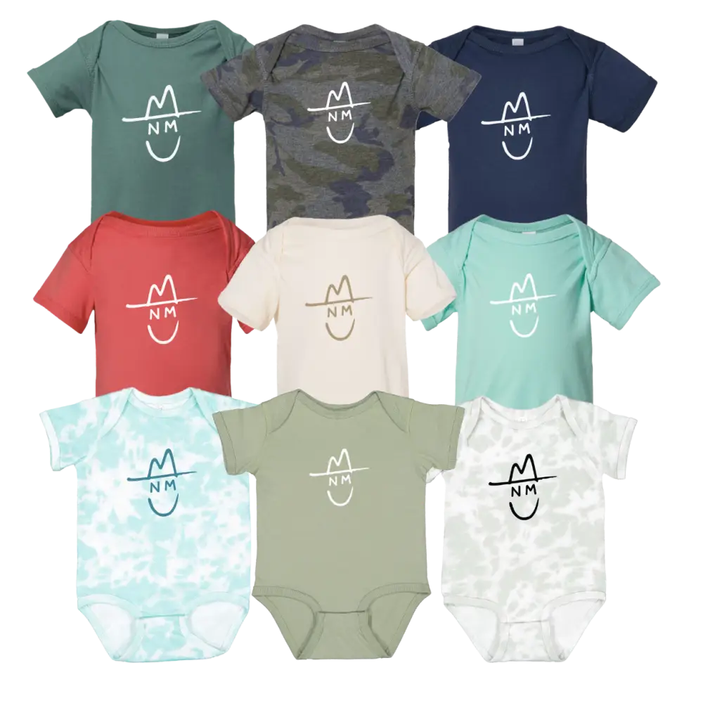 Nine infant onesies in assorted solid and patterned colors, each featuring a white or black minimalist logo of a hat with ’nm’ initials.