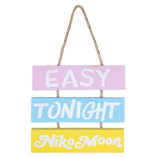 Hanging decorative sign with three colorful panels reading ’EASY TONIGHT NIKO MOON’ connected by rope.