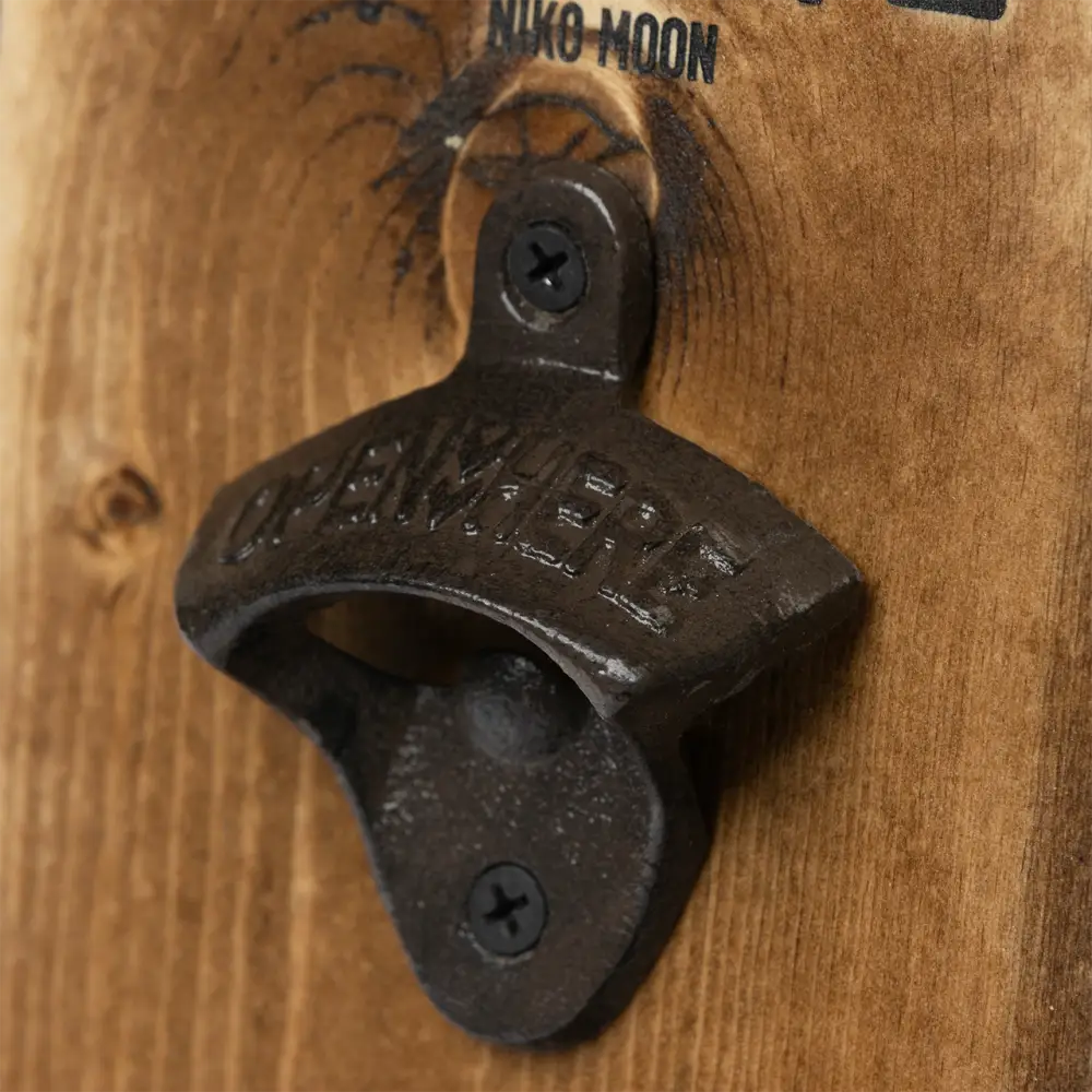 Wall-mounted bottle opener made of cast iron.