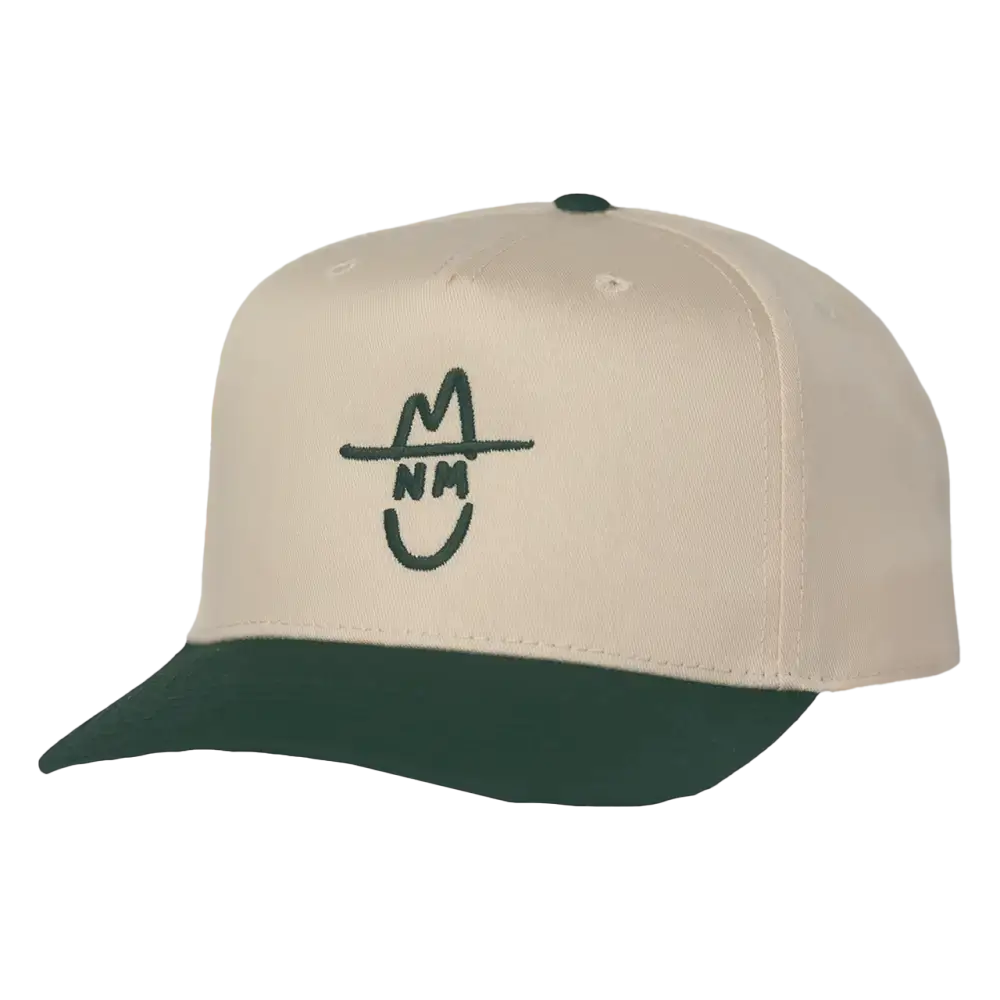 Cream-colored baseball cap with a dark green brim and matching button, featuring a stylized black embroidered logo of a smiling face wearing a hat.