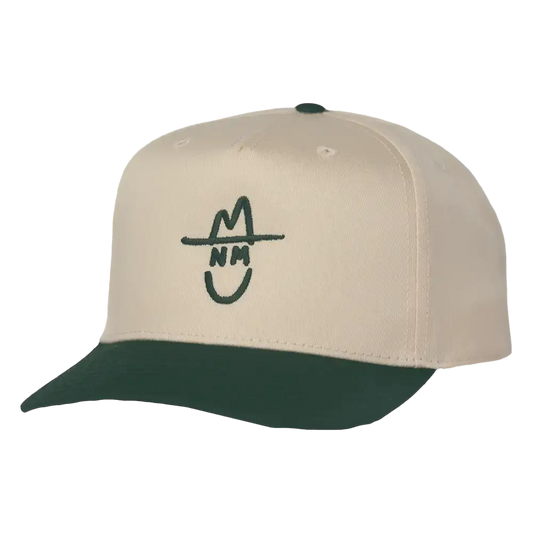 Cream-colored baseball cap with a dark green brim and matching button, featuring a stylized black embroidered logo of a smiling face wearing a hat.