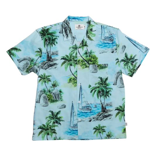 Light blue hawaiian shirt featuring a tropical print of palm trees, sailboats, and rocky shores in shades of green, gray, and turquoise.