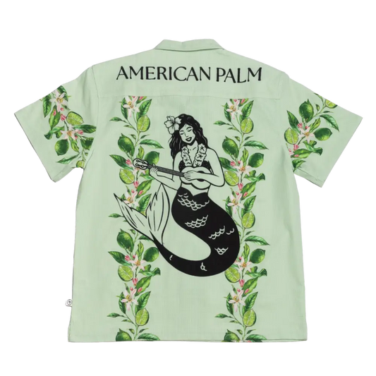 Light green american palm hawaiian shirt featuring a black mermaid playing a ukulele surrounded by tropical foliage.