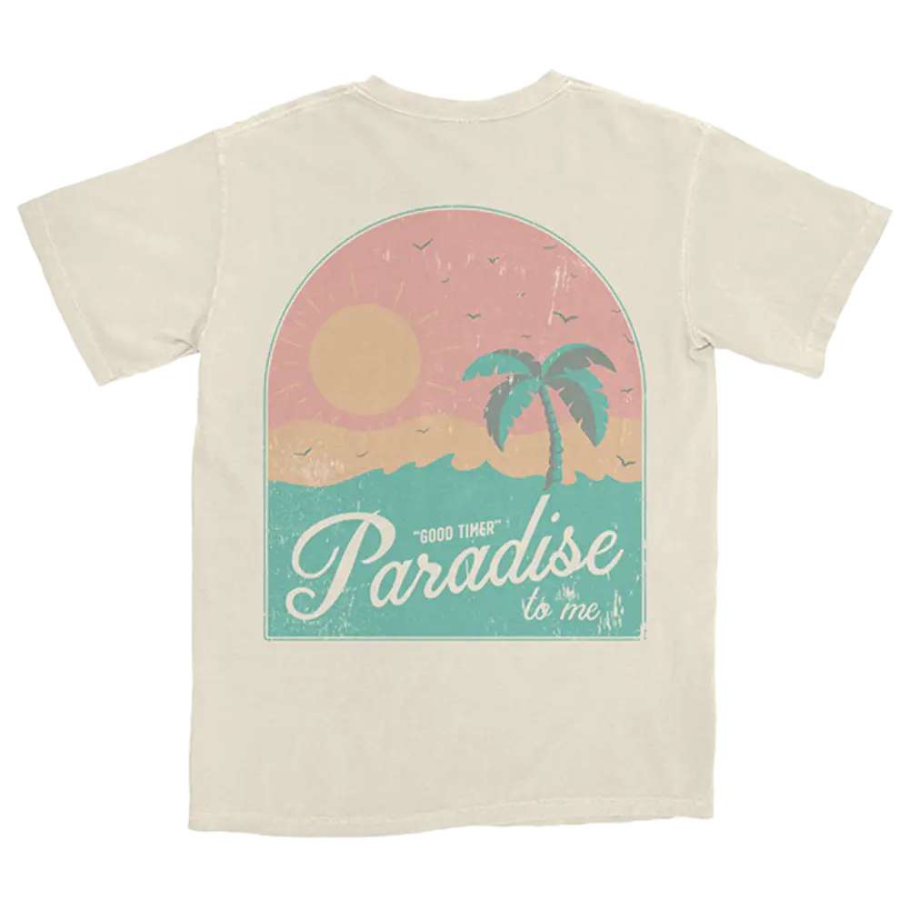 Beige t-shirt with a tropical paradise design featuring a palm tree, sun, and text.