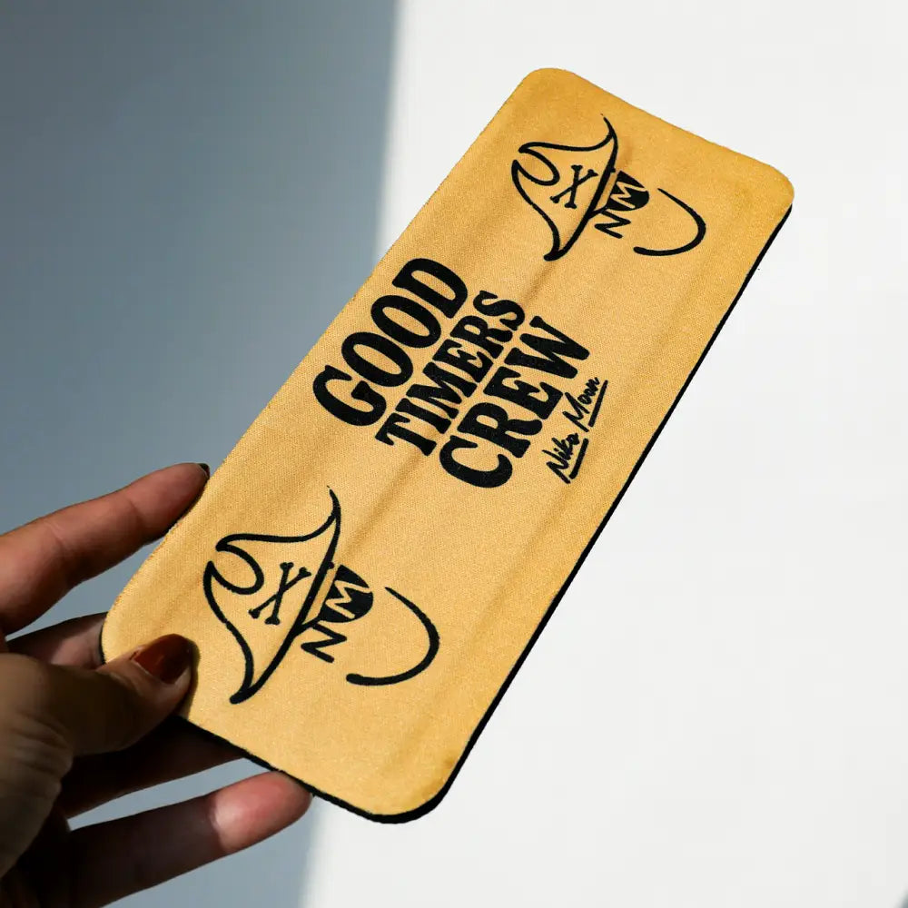 Yellow fabric phone case with black ’good timers crew’ text and logo design