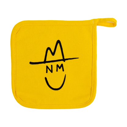 Yellow pot holder with a simple black line drawing of a smiling face wearing a hat.
